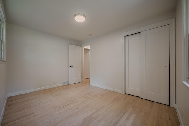 51 Brentley Dr, Shelton, CT 06484 - unfurnished bedroom featuring light wood-style flooring and a closet