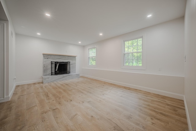 51 Brentley Dr, Shelton, CT 06484 - unfurnished living room featuring healthy amount of natural light, a fireplace, wood finished floors, and recessed lighting