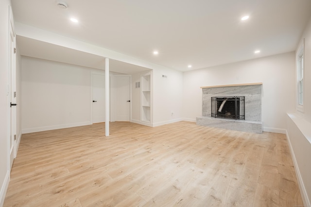 51 Brentley Dr, Shelton, CT 06484 - unfurnished living room with a high end fireplace, light wood finished floors, and recessed lighting