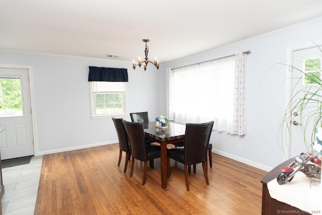 24 Dogwood Ln, Shelton, CT 06484 - dining space with a chandelier, plenty of natural light, light wood-type flooring, and ornamental molding