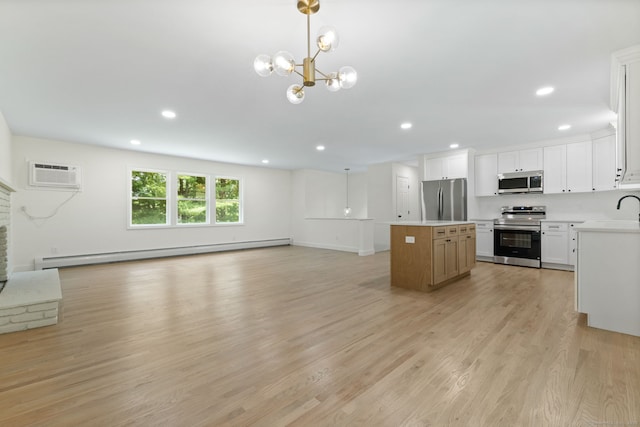 95 Great Ring Rd, Newtown, CT 06482 - kitchen featuring appliances with stainless steel finishes, a baseboard radiator, a wall mounted air conditioner, open floor plan, and a center island
