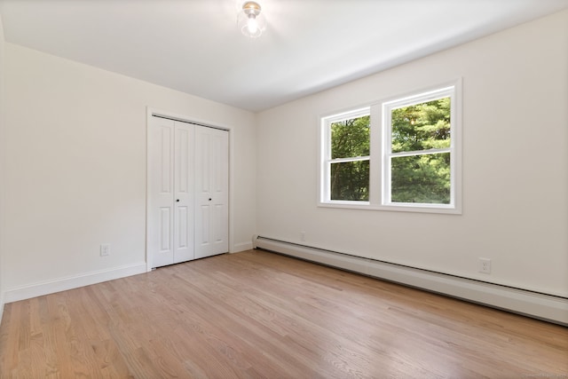 95 Great Ring Rd, Newtown, CT 06482 - unfurnished bedroom with baseboard heating, light wood finished floors, and a closet