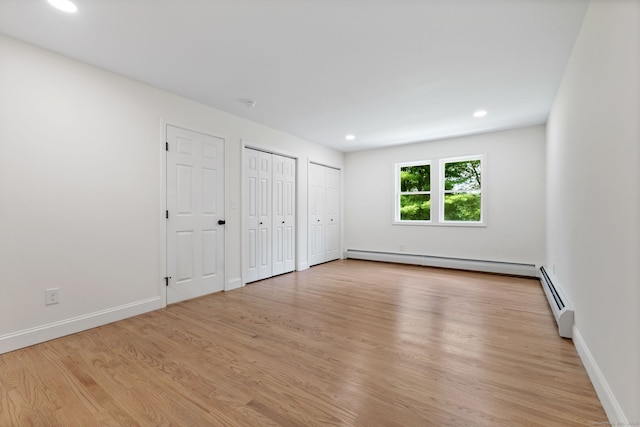 95 Great Ring Rd, Newtown, CT 06482 - unfurnished bedroom with a baseboard radiator, multiple closets, light wood-type flooring, and recessed lighting