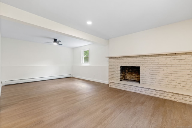 95 Great Ring Rd, Newtown, CT 06482 - unfurnished living room with a baseboard heating unit, wood finished floors, a brick fireplace, a ceiling fan, and recessed lighting
