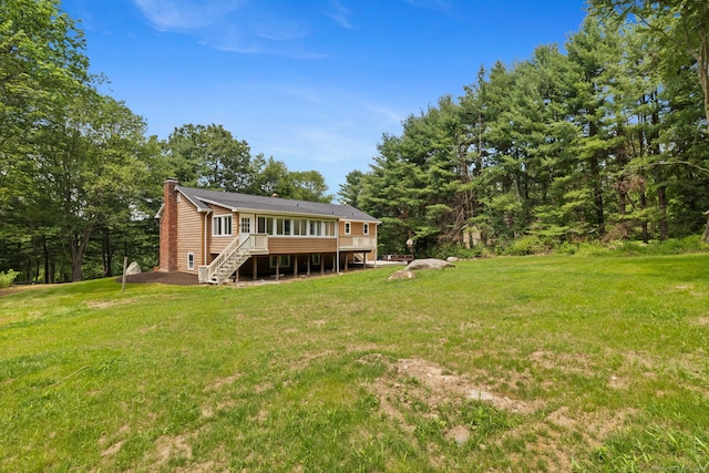 95 Great Ring Rd, Newtown, CT 06482 - back of property with a chimney, stairway, a wooden deck, and a lawn