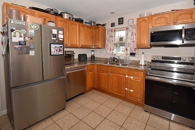 30 Foxcroft Dr, Manchester, CT 06040 - kitchen with appliances with stainless steel finishes, dark stone countertops, and light tile patterned floors