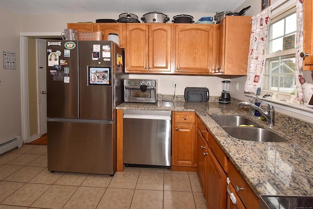 30 Foxcroft Dr, Manchester, CT 06040 - kitchen featuring appliances with stainless steel finishes, light tile patterned flooring, brown cabinetry, and light stone counters