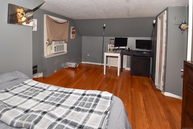 30 Foxcroft Dr, Manchester, CT 06040 - bedroom with wood finished floors, cooling unit, a textured ceiling, vaulted ceiling, and a desk