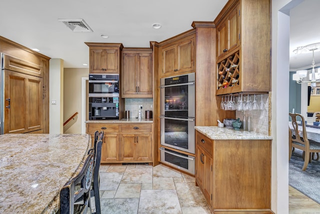 206 Beacon Hill Rd, Trumbull, CT 06611 - kitchen with double oven, a warming drawer, backsplash, brown cabinets, and recessed lighting
