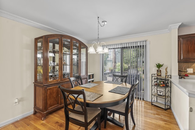 60 Alvord Ln Apt 19, Stamford, CT 06902 - dining room with light wood finished floors, a chandelier, and crown molding