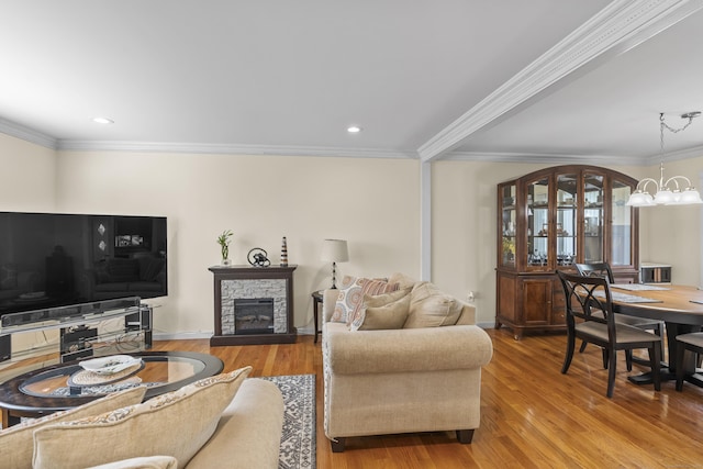 60 Alvord Ln Apt 19, Stamford, CT 06902 - living room with wood finished floors, ornamental molding, a stone fireplace, a chandelier, and recessed lighting