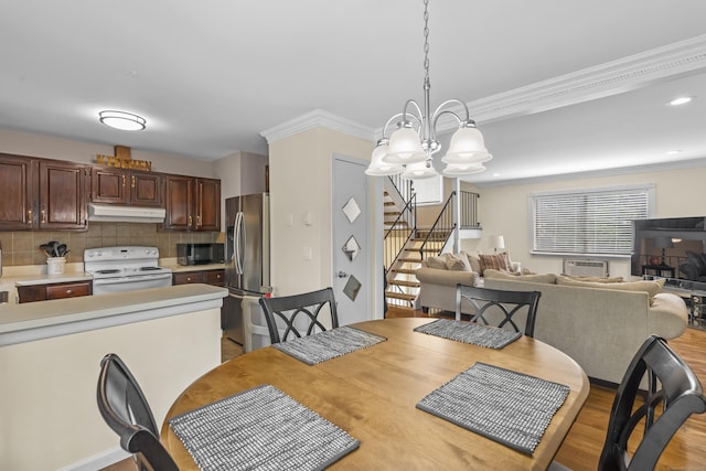 60 Alvord Ln Apt 19, Stamford, CT 06902 - dining room with stairs, a chandelier, ornamental molding, light wood-type flooring, and a wall mounted air conditioner