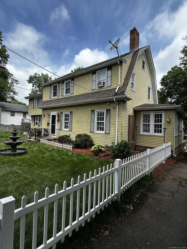54 Carmel St, Hamden, CT 06518 - view of front of home featuring a chimney, a fenced front yard, a shingled roof, and a gambrel roof