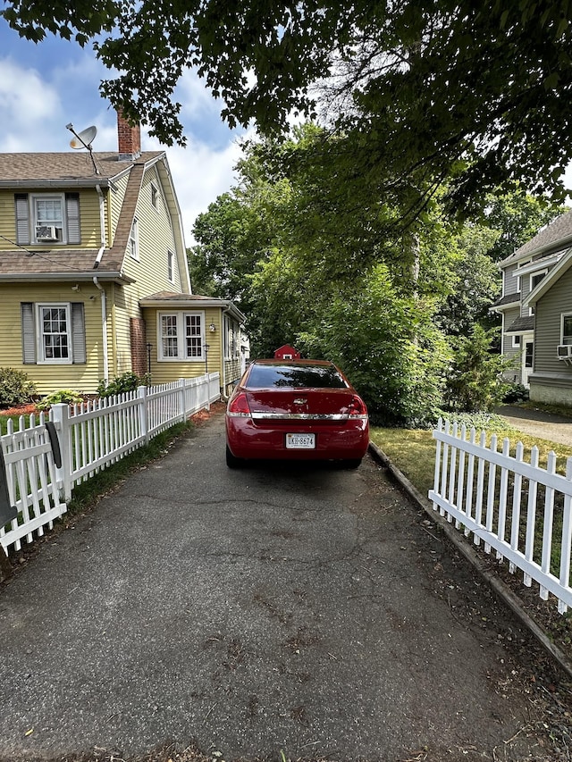 54 Carmel St, Hamden, CT 06518 - view of home's exterior with a gambrel roof, a chimney, and driveway
