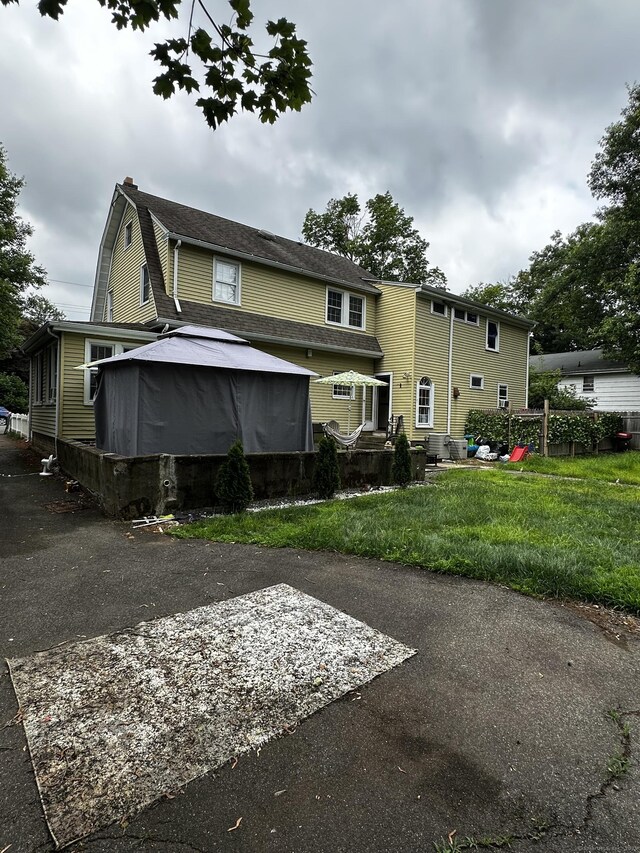 54 Carmel St, Hamden, CT 06518 - rear view of house with a gazebo and a chimney