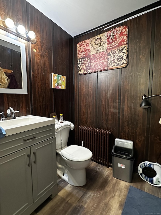 54 Carmel St, Hamden, CT 06518 - half bath with radiator heating unit, vanity, wood finished floors, and wood walls