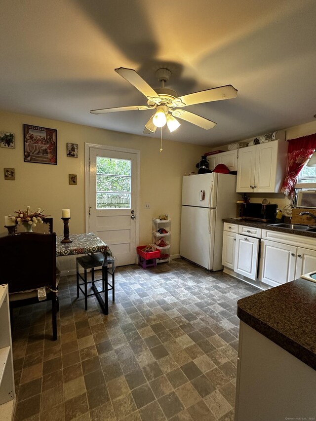 54 Carmel St, Hamden, CT 06518 - kitchen with freestanding refrigerator, dark countertops, white cabinetry, and a ceiling fan