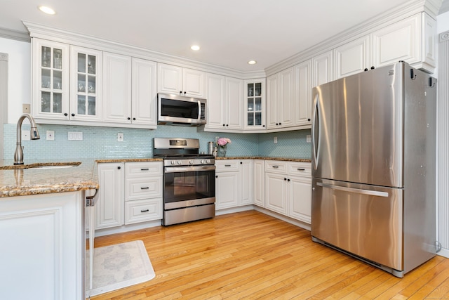 41 Arlington Rd, Stamford, CT 06902 - kitchen with appliances with stainless steel finishes, light wood-style floors, white cabinets, and recessed lighting
