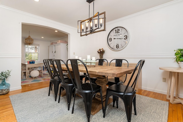 41 Arlington Rd, Stamford, CT 06902 - dining room with a chandelier, light wood-style flooring, ornamental molding, arched walkways, and recessed lighting