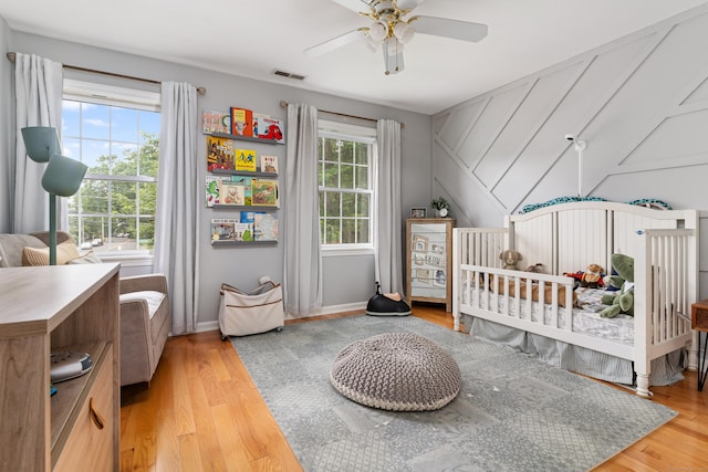 41 Arlington Rd, Stamford, CT 06902 - bedroom with light wood finished floors, a nursery area, and ceiling fan