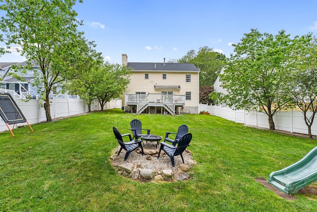 41 Arlington Rd, Stamford, CT 06902 - fenced backyard with a fire pit, a playground, and a deck
