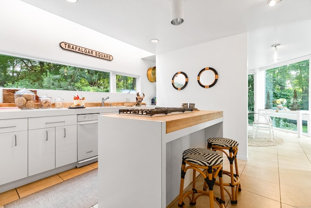 274 Nod Rd, Ridgefield, CT 06877 - kitchen featuring light tile patterned floors, healthy amount of natural light, a breakfast bar, and recessed lighting