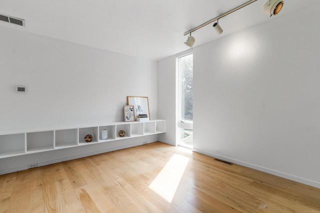274 Nod Rd, Ridgefield, CT 06877 - empty room with rail lighting and hardwood / wood-style flooring