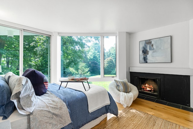 274 Nod Rd, Ridgefield, CT 06877 - bedroom with a warm lit fireplace and wood finished floors