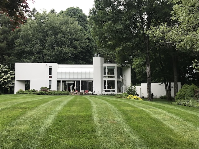 274 Nod Rd, Ridgefield, CT 06877 - back of property featuring a yard, a chimney, and stucco siding