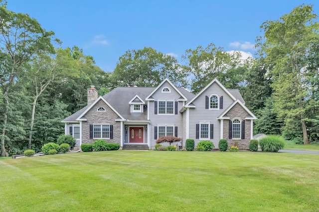 28 Aldo Dr, Woodbridge, CT 06525 - view of front facade with stone siding, a front yard, and a chimney
