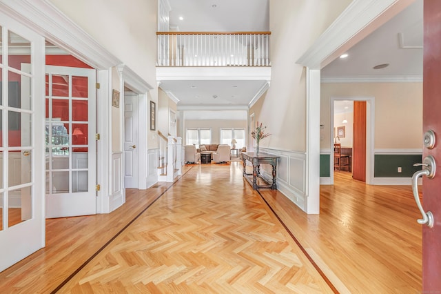 28 Aldo Dr, Woodbridge, CT 06525 - foyer entrance with crown molding, a wainscoted wall, a towering ceiling, french doors, and a decorative wall