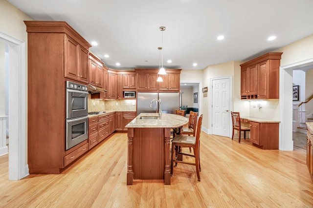 28 Aldo Dr, Woodbridge, CT 06525 - kitchen with appliances with stainless steel finishes, light wood-type flooring, brown cabinets, a kitchen breakfast bar, and recessed lighting