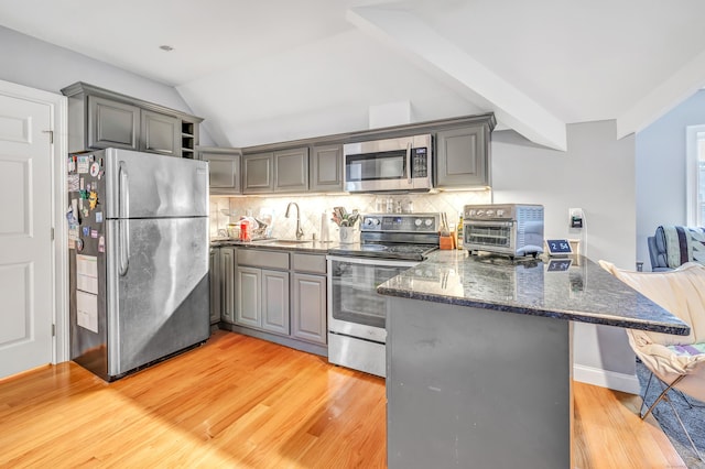 28 Aldo Dr, Woodbridge, CT 06525 - kitchen with stainless steel appliances, gray cabinets, a peninsula, dark stone countertops, and vaulted ceiling
