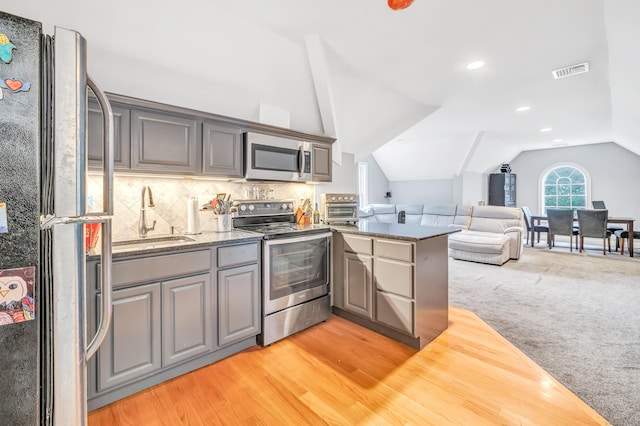 28 Aldo Dr, Woodbridge, CT 06525 - kitchen with appliances with stainless steel finishes, gray cabinetry, lofted ceiling, open floor plan, and a peninsula