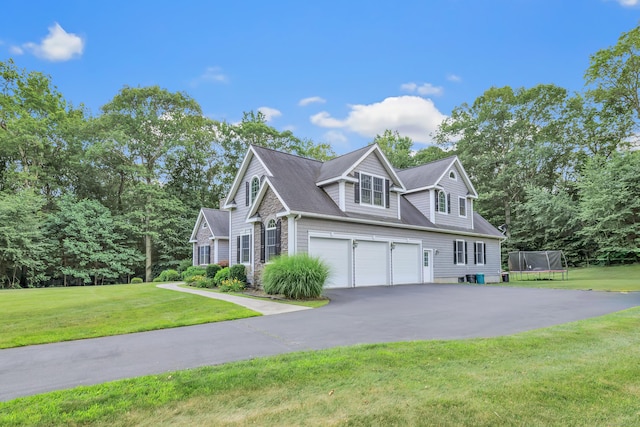 28 Aldo Dr, Woodbridge, CT 06525 - view of front of house with a trampoline, driveway, an attached garage, and a front yard