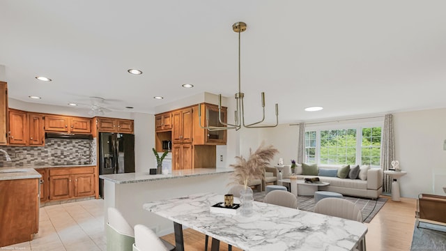 151 Stevenson Rd, Meriden, CT 06451 - kitchen with under cabinet range hood, a peninsula, backsplash, recessed lighting, and brown cabinets