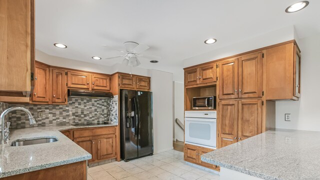 151 Stevenson Rd, Meriden, CT 06451 - kitchen featuring black appliances, under cabinet range hood, a ceiling fan, tasteful backsplash, and light stone countertops