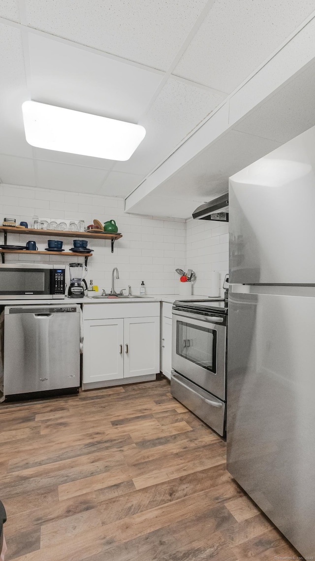 151 Stevenson Rd, Meriden, CT 06451 - kitchen with appliances with stainless steel finishes, white cabinetry, decorative backsplash, and open shelves