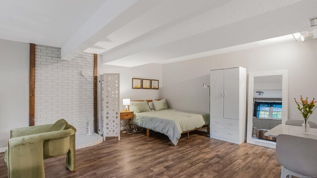 151 Stevenson Rd, Meriden, CT 06451 - bedroom featuring wood finished floors, beamed ceiling, and brick wall