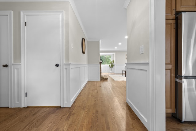 518 Iroquois Ln Unit A, Stratford, CT 06614 - hallway with a decorative wall, wood finished floors, a wainscoted wall, and crown molding