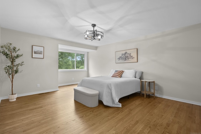 518 Iroquois Ln Unit A, Stratford, CT 06614 - bedroom featuring a chandelier and light wood-style flooring