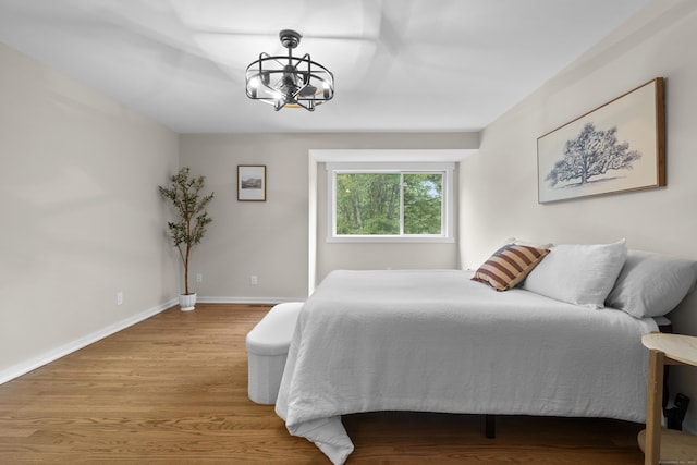 518 Iroquois Ln Unit A, Stratford, CT 06614 - bedroom featuring a chandelier and wood finished floors