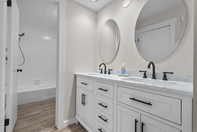 518 Iroquois Ln Unit A, Stratford, CT 06614 - full bathroom featuring double vanity, wood finished floors, and shower / bathtub combination