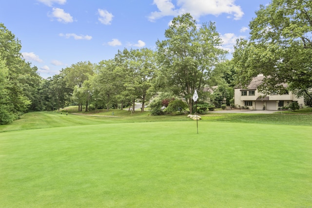 518 Iroquois Ln Unit A, Stratford, CT 06614 - view of property's community featuring a yard, view of wooded area, an area to practice putting, and view of golf course
