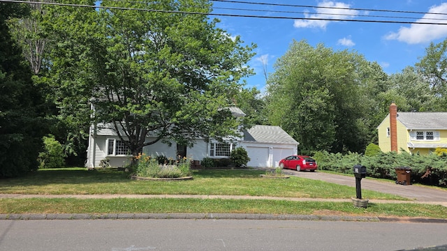 31 Glenwood Rd, Wethersfield, CT 06109 - view of property hidden behind natural elements featuring a garage and a front yard