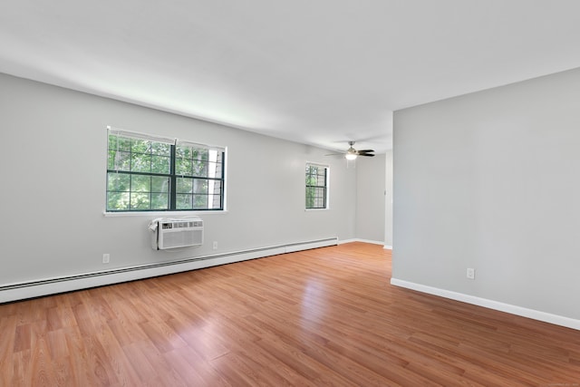 37 Enid St Apt C, Bridgeport, CT 06606 - empty room featuring a wall unit AC, wood finished floors, healthy amount of natural light, and a baseboard radiator