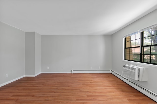 37 Enid St Apt C, Bridgeport, CT 06606 - empty room with baseboard heating, light wood-type flooring, and a baseboard heating unit