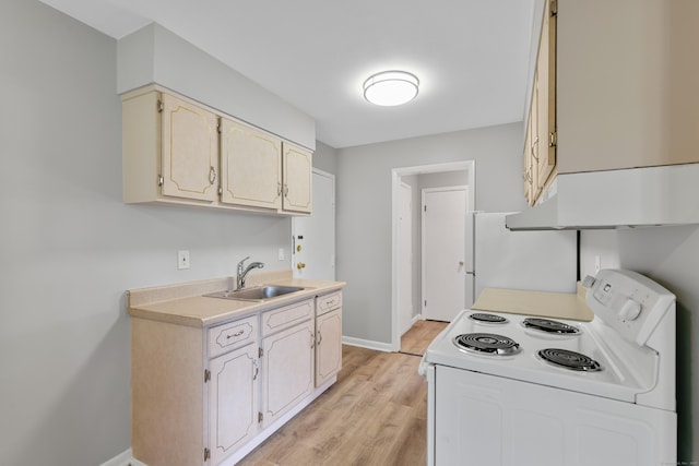 37 Enid St Apt C, Bridgeport, CT 06606 - kitchen featuring white electric range, light countertops, light wood-style flooring, and refrigerator