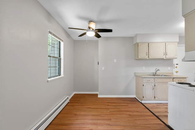 37 Enid St Apt C, Bridgeport, CT 06606 - kitchen with white electric range oven, a baseboard radiator, a ceiling fan, light wood-style flooring, and light countertops