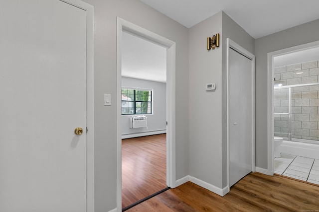 37 Enid St Apt C, Bridgeport, CT 06606 - corridor featuring a wall mounted air conditioner, wood finished floors, and a baseboard heating unit